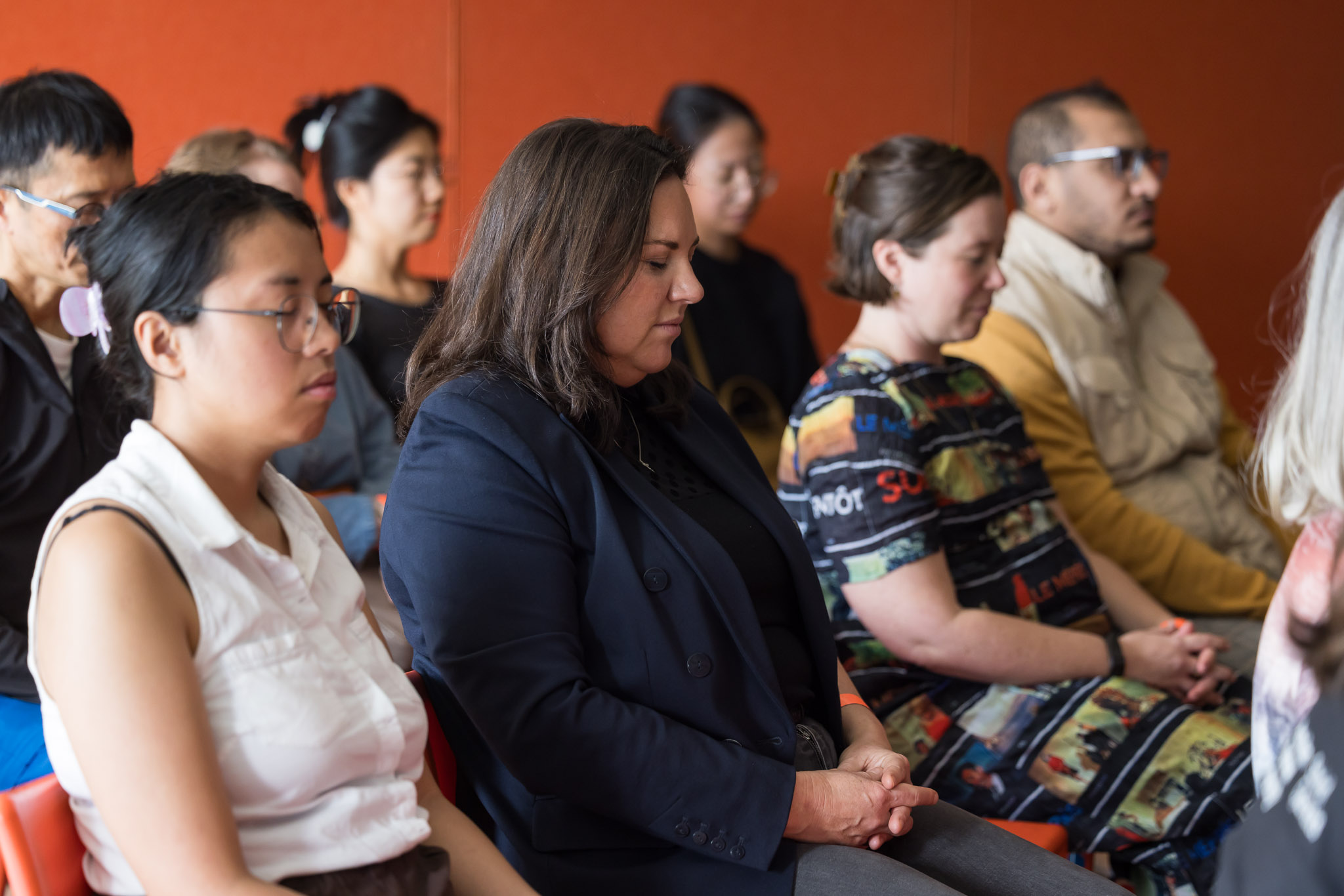 Group of people sitting with their eyes closed