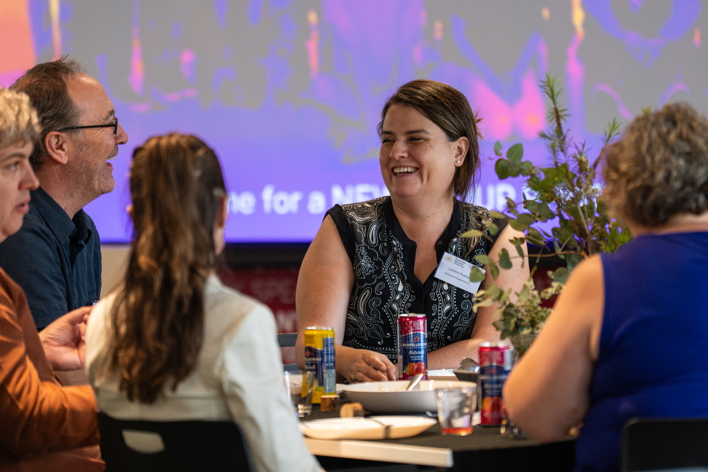 Staff and Alumni sit together, connecting and sharing