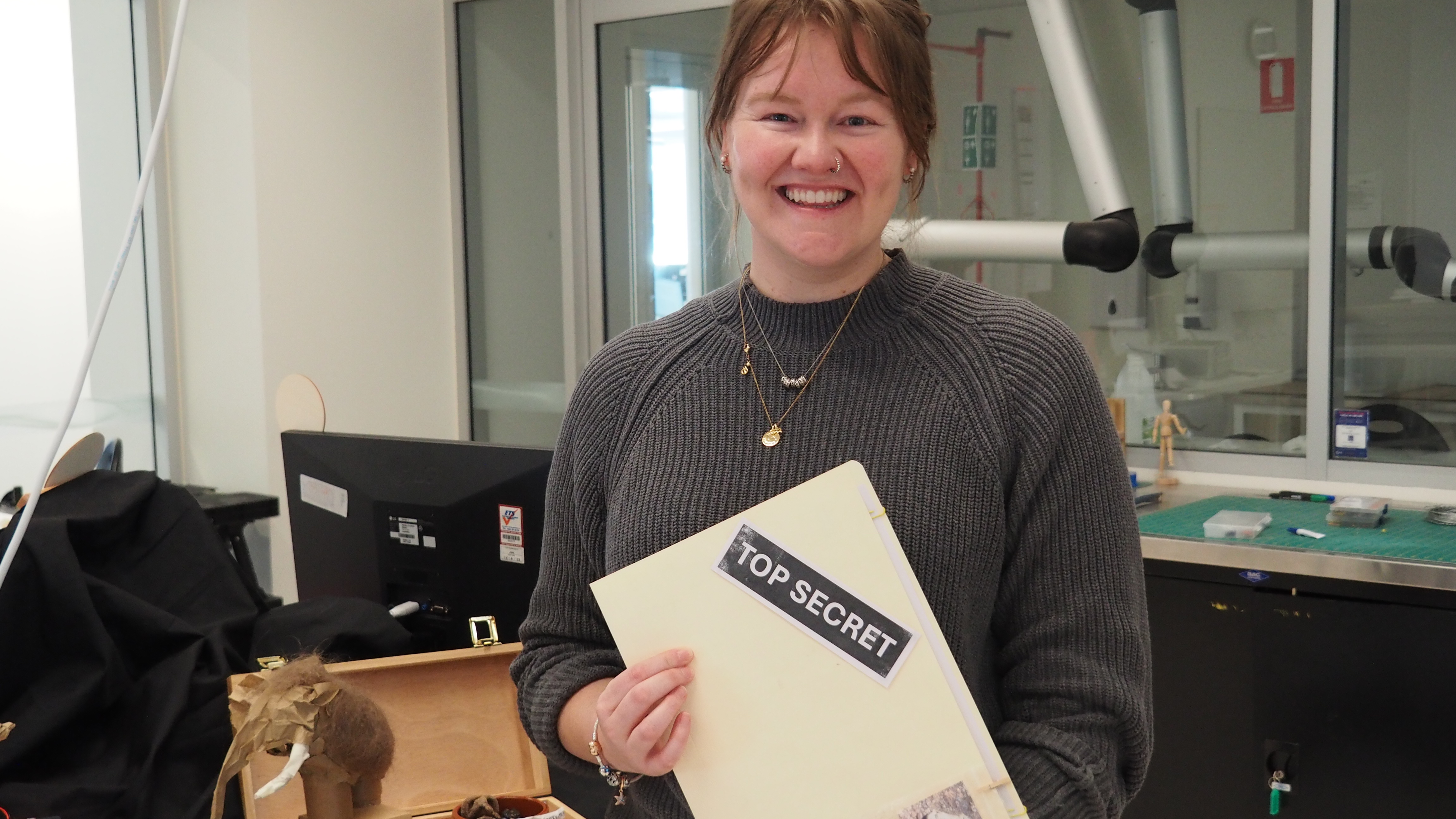 Alisha poses with components of her installation display.